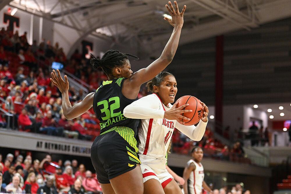 Senior center Camille Hobby drives the ball around an opponent during the game against USF in Reynolds Coliseum on Sunday, Dec. 11, 2022. Hobby scored 10 points and made seven rebounds for the Wolfpack. NC State beat USF 65-57.