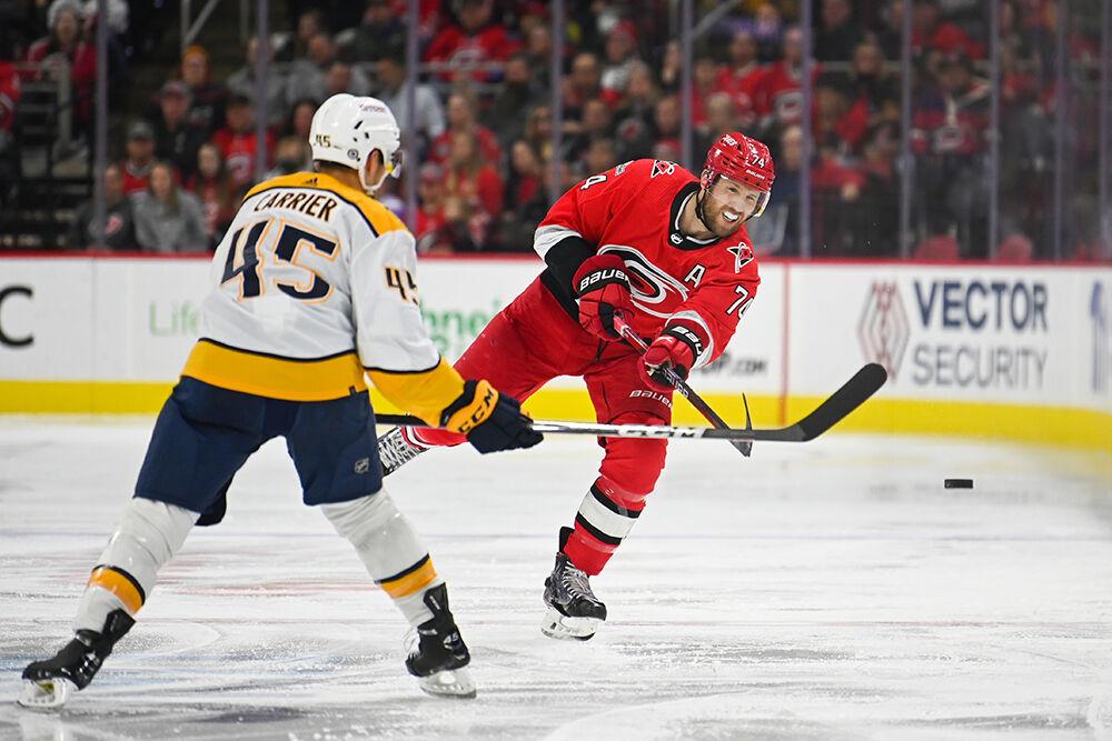 Defenseman Jaccob Slavin passes the puck during the game against the Nashville Predators in PNC Arena on Thursday, Jan. 5, 2023. The Hurricanes lost 5-3.