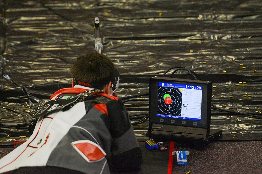Sophomore Ben Salas aims at a target at the NC State versus West Virginia rifle match at Reynolds Coliseum on Sunday, Oct. 17, 2021. NC State lost 4730-4652 against West Virginia.