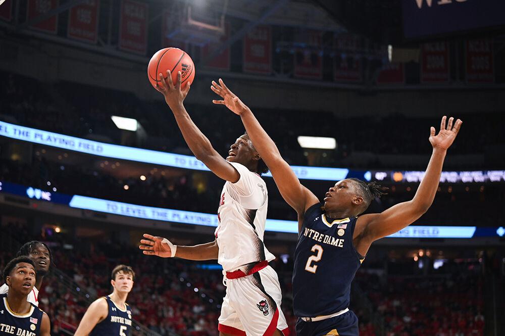 Graduate guard Jarkel Joiner shoots a contested shot over a defender during the Wolfpack's game against the Notre Dame Fighting Irish at PNC Arena on Tuesday, Jan. 24, 2022. Joiner shot for 28 points and got six rebounds as the Wolfpack beat the Fighting Irish 85-82.