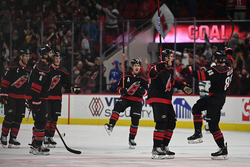 The Carolina players celebrate a game-tying goal in the last seconds of the third period of the Hurricanes' home game against the San Jose Sharks in PNC Arena on Friday, Jan. 27, 2023. The Canes came from behind by scoring three unanswered goals and beat the Sharks 5-4 in overtime.