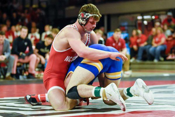 Sophomore Isaac Trumble grapples his opponent during the NC State duel against Pitt in Reynolds Coliseum on Friday, Feb. 10, 2023. NC State beat Pitt 23-9.