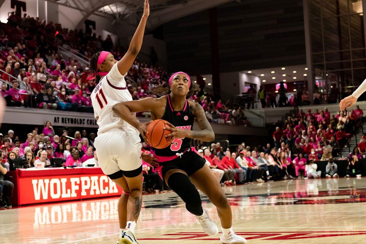 Senior forward Jada Boyd bypasses opponent defense during the annual Play4Kay game against Virginia Tech at Reynolds Coliseum on Monday, February 6, 2023. Boyd made one block. NC State lost to Virginia Tech 73-61.