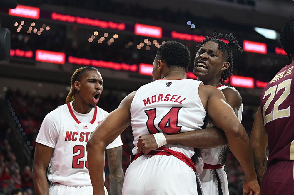 Redshirt junior forward Greg Gannt (left), celebrates as sophomore guard Terquavion Smith (right) hugs senior guard Casey Morsell during the Wolfpack's home basketball game against the Florida State Seminoles in PNC Arena on Wednesday, Feb. 1, 2023. The Wolfpack beat the Seminoles 94-66.