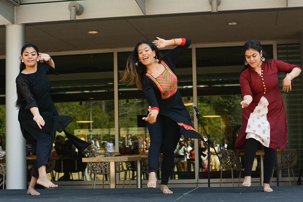 Pritha Bose, second-year graduate student studying economics, Lumana Shakya, a second-year doctoral student studying economics, and Soumi Chandra, a second-year doctoral student studying economics, dance at the International Festival on Stafford Commons on Friday, March 24, 2023. The festival is an annual cultural showcase encouraging interaction between individuals of different backgrounds.
