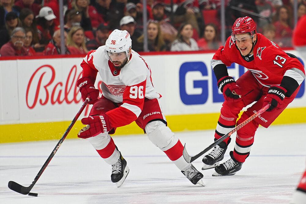 Carolina Hurricanes right wing Jesse Puljujarvi defends Detroit Red Wings opponent in PNC Arena on Tuesday, April 11, 2023. The Hurricanes won 4-1.