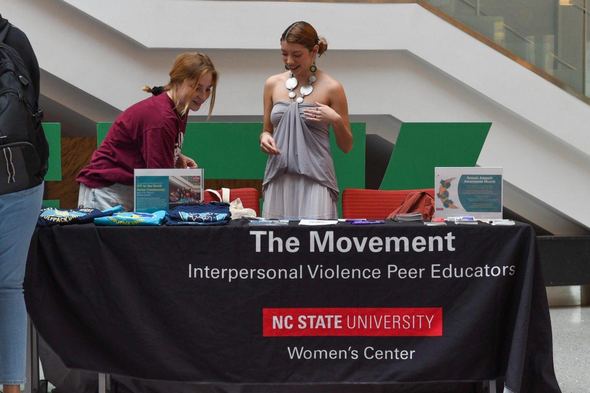 Kelsie Johnson (left), a second-year studying communication, and Ruby Hernandez (right), a fourth-year studying social work, tend to the table for the Sexual Assault Awareness Month Kickoff in Talley Student Union on April 3, 2023. The Movement, a group of peer educators on interpersonal violence, provided information about Sexual Assault Awareness Month.
