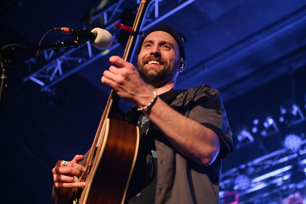 Ruston Kelly looks out into the crowd and smiles while playing the guitar during his concert at Lincoln Theatre in Raleigh on Saturday, April 15, 2023. Kelly played 21 songs including hits "Mockingbird" and "The Weakness."