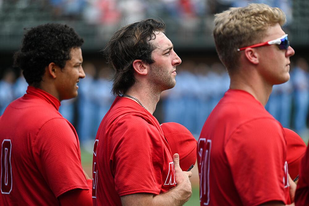 Junior pitcher Rio Britton, sophomore pitcher Win Scott and junior pitcher Justin Lawson hold their hats across their heart while the national anthem plays before the game against UNC-Chapel Hill at Bryson Field at Boshamer Stadium on Saturday, May 13, 2023. NC State lost to UNC-CH 12-2.