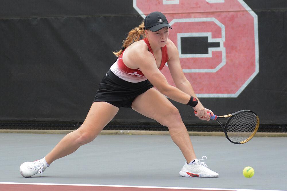 Junior Sophie Abrams kneels to reach the ball during the NCAA Tournament match against Auburn at Dail Outdoor Tennis Stadium on Saturday, May 13, 2023. Abrams won her singles match 6-1, 6-1. The Wolfpack defeated the Tigers 4-0.