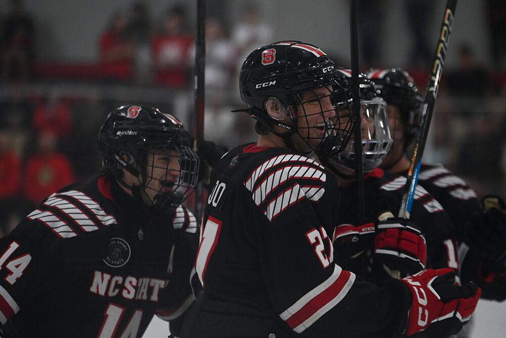 Freshman forward Nick Shook (center) smiles as he celebrates a goal with senior forward Drew Bresingham (left) and freshman defenseman Jackson Strong (right) during the game against ECU at Wake Competition Center on Friday, Sept. 8, 2023. The Icepack won 17-3.