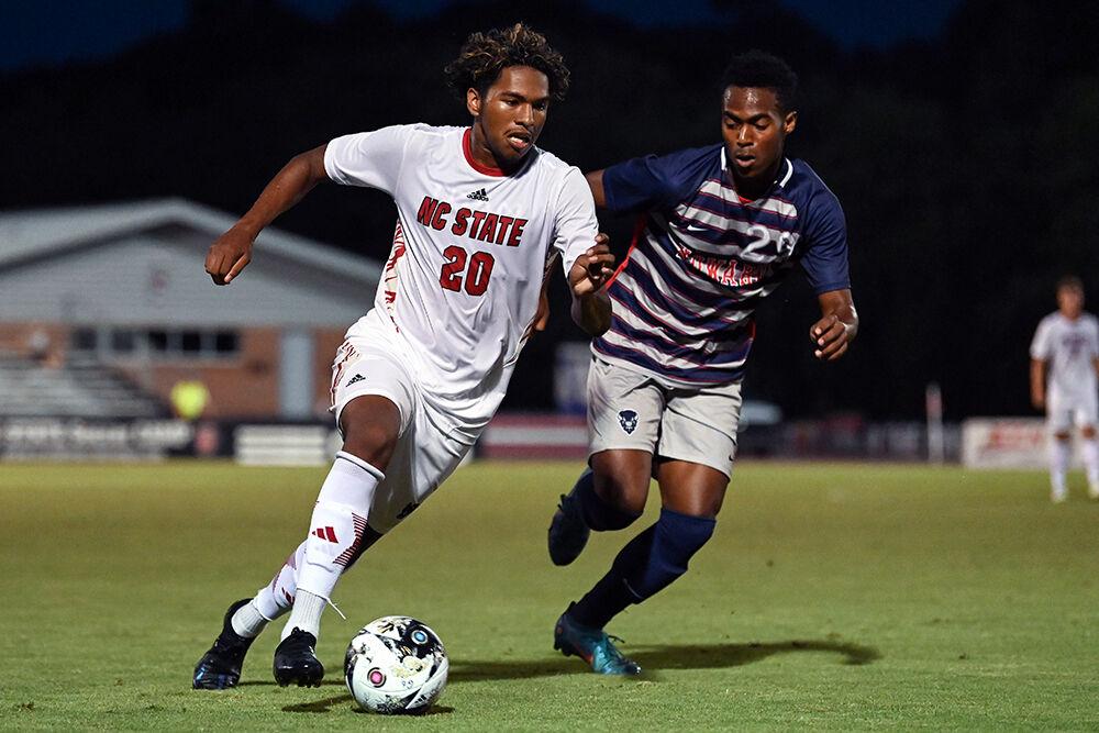 Sophomore defender Jonathan Cisneros dribbles the ball away from an opponent during the match against Howard at Dail Soccer Field on Tuesday, Sept. 12, 2023. NC State beat Howard 3-1.