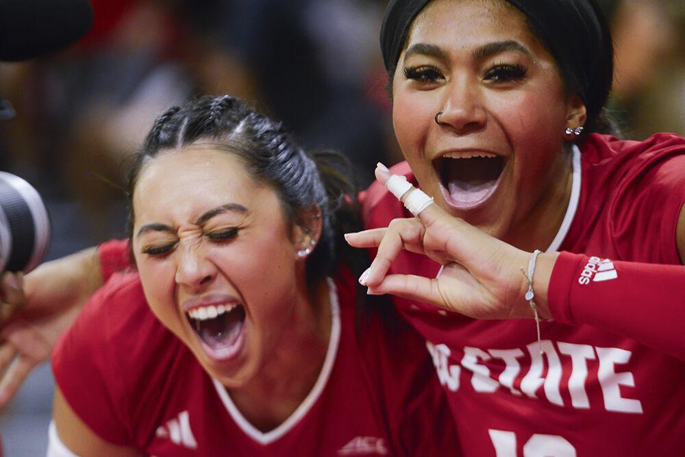 Graduate setter Kristen McDaniel and junior middle blocker Jada Allen celebrate their victory against Louisville in Reynolds Coliseum on Sunday, Oct. 1, 2023. NC State beat Louisville 3-1.