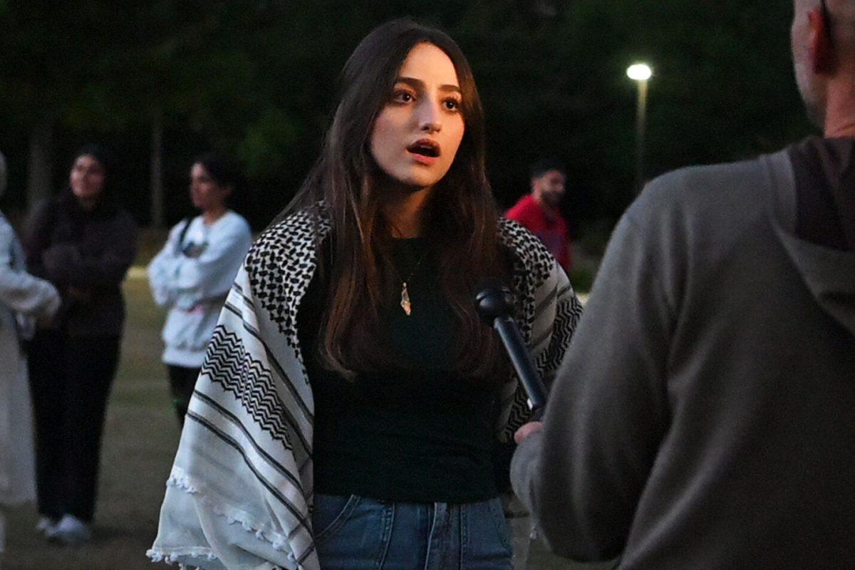 Lara Yassin, a fourth-year studying business, gives an interview after the vigil for Palestine hosted by the Arab Student Organization on Wednesday, Oct. 19, 2023. Yassin gave a speech during the vigil. The vigil was held to honor lives lost in the war in Palestine.