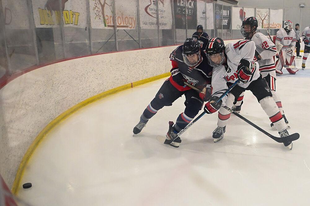 Freshman defender Jack Strong fights to gain control of the puck in the game against Liberty at Wake Competition Center on Thursday, Oct. 5, 2023. The Icepack won the game 5-3.