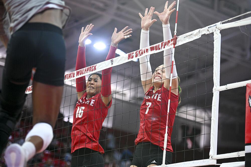 Junior middle blocker Jada Allen and sophomore outside hitter Ava Brizzard jumps to block the ball during the match against Louisville in Reynolds Coliseum on Sunday, Oct. 1, 2023. NC State beat Louisvile 3-1.
