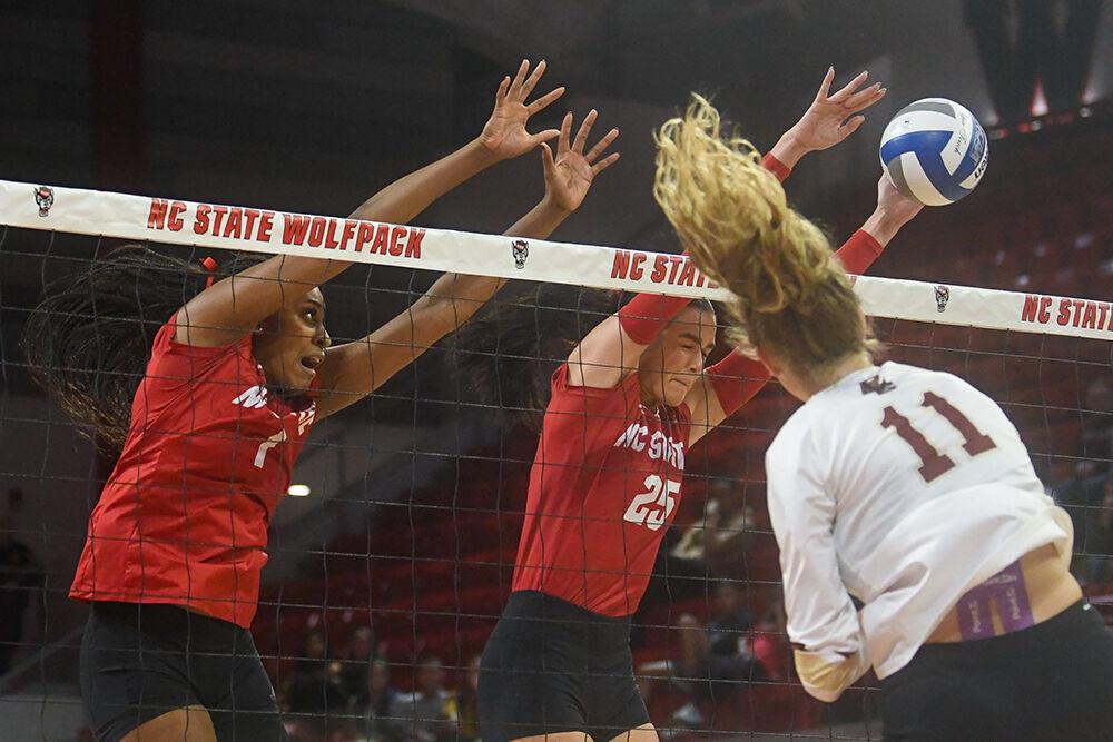 Redshirt junior outside hitter Madison Williams (left) and senior middle blocker Riley Shaak (right) reach to block the ball in the match against Boston College inside Reynolds Coliseum on Friday, Nov. 3, 2023. NC State lost the match to Boston College 3-2.