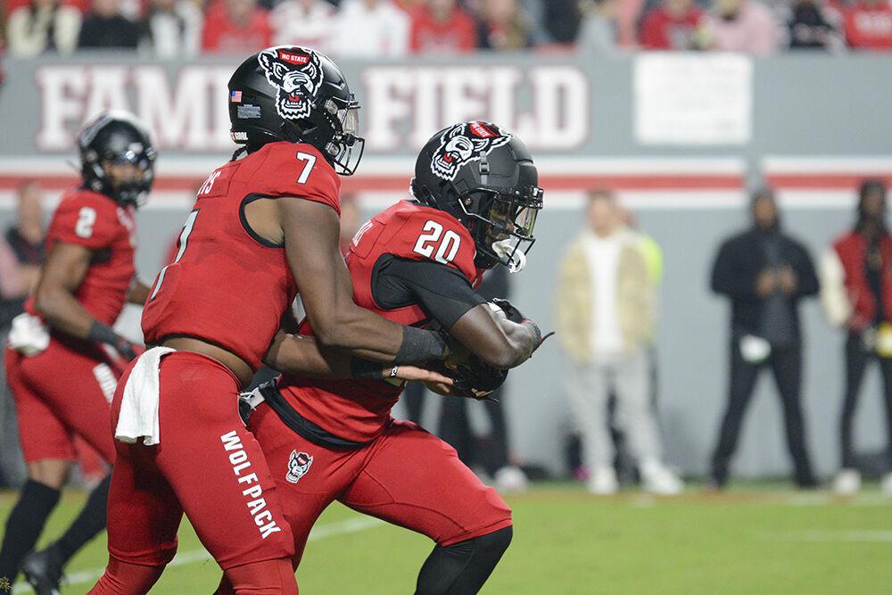 Sophomore quarterback MJ Morris hands the ball off to freshman running back Kendrick Raphael during the football game against Miami at Carter-Finley Stadium on Saturday, Nov. 11, 2023. Morris and Raphael both made one touchdown. NC State beat Miami 20-6.