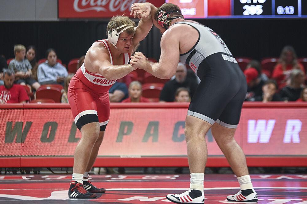 Heavyweights redshirt freshman Chase Horne and redshirt junior Owen Trephan lock hands during the NC State Wrestle-Offs in Reynolds Coliseum on Friday, Oct. 27, 2023. Trephan beat Horne 7-3 in the 285 bout.
