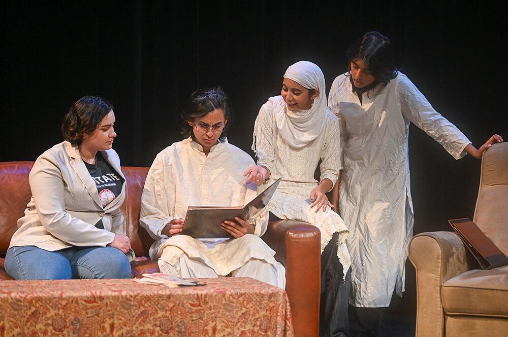 (From left to right) Greta Estefania Perez Cobo, a third-year studying sociology and industrial engineering, Fayaz Shaikh, a fourth-year studying computer engineering, Unnati Bukhariya, a graduate student in computer science, and Oviya NagarajPrema, a second-year studying art and design, gaze at a photo album during the performance of "What We Grew Up With" in Kennedy-McIlwee Studio Theatre on Thursday, Nov. 2, 2023. "What We Grew Up With" ran from Nov. 2-5, 2023.