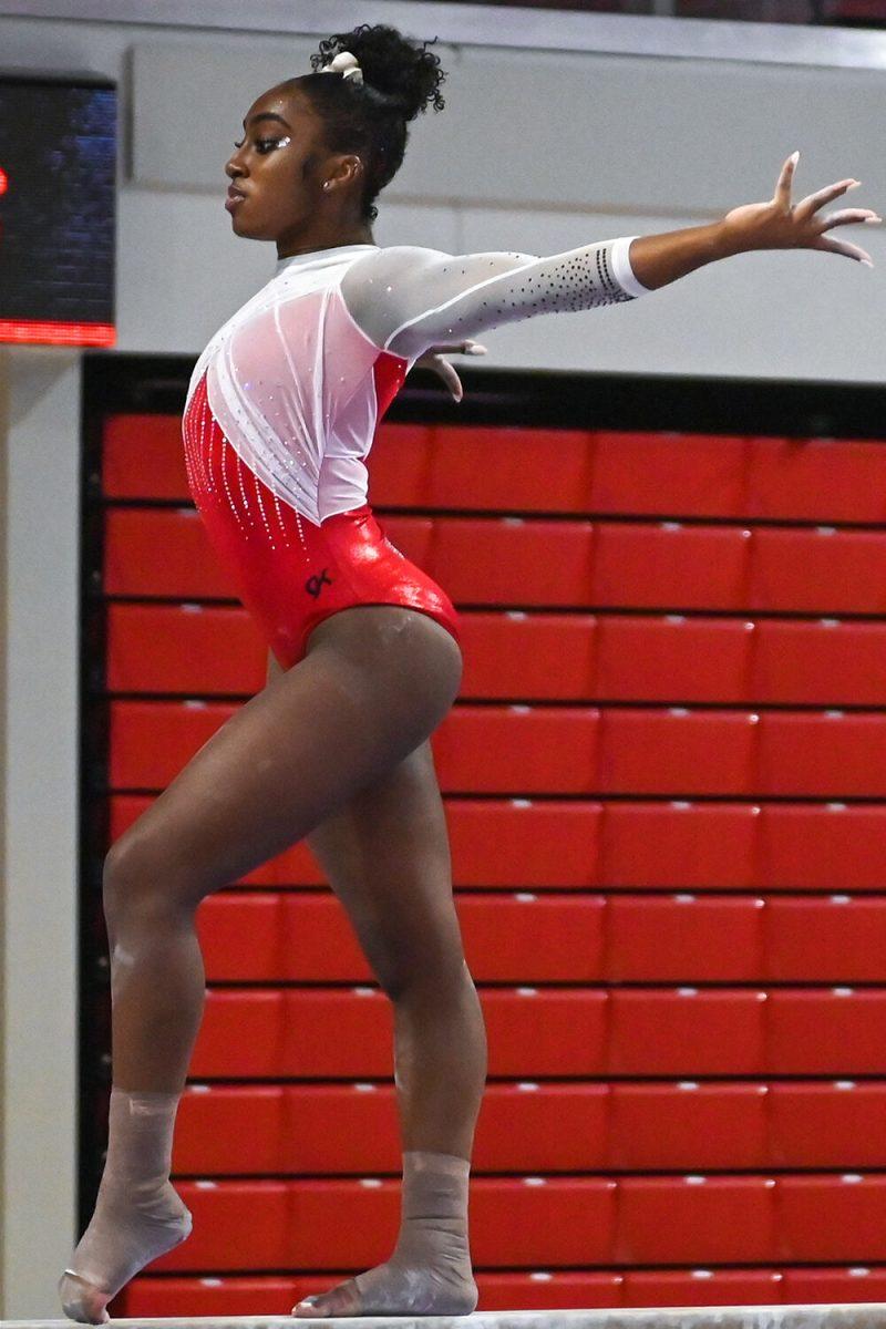 Senior Madison Benson performs her routine on the balance beam during the Red and White exhibition meet at Reynolds Coliseum on Sunday, Dec. 17, 2023. The Red team defeated the White team 3-1.