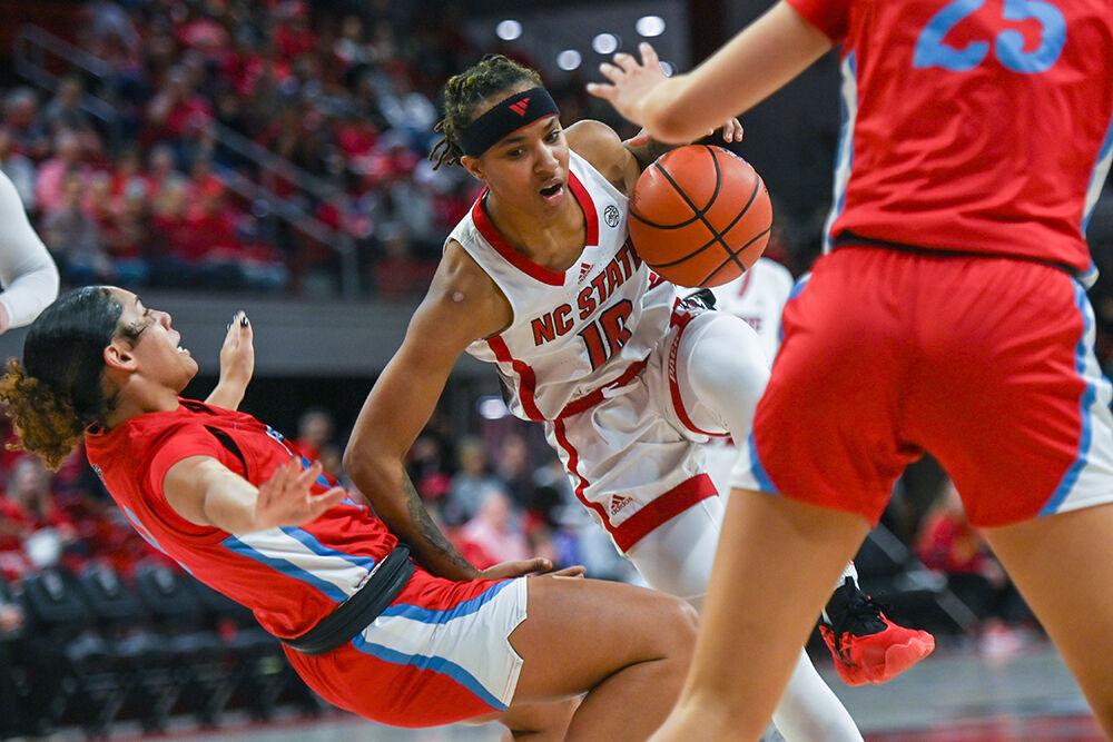 Junior guard Aziaha James accidentally runs into her opponent during the game against Liberty at Reynolds Coliseum on Sunday, Dec. 10, 2023. James scored 18 points for NC State. NC State beat Liberty 80-67.