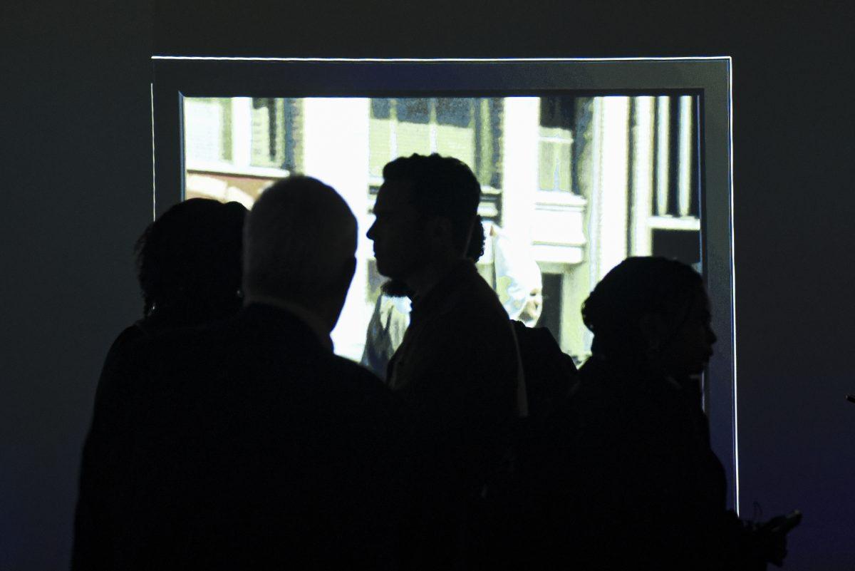 Visitors walk around the Cyma Rubin Visualization Gallery to look at the digital installation that was curated as a part of King &amp; The Klan: A Visual Experience, in D.H. Hill Jr. Library on Wednesday, Jan. 17, 2024. The installation featured newly developed footage of Rev. Martin Luther King, Jr.'s visit to Reynolds Coliseum following a KKK protest on July 31, 1966.