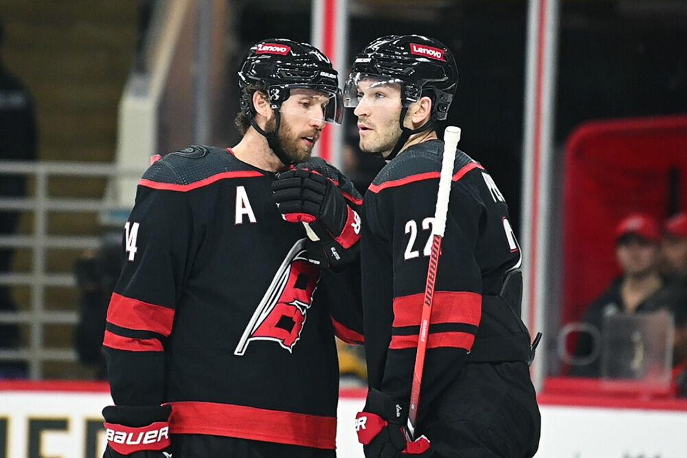 Defensemen Jaccob Slavin and Brett Pesce talk to each other during the Carolina Hurricanes game versus the Pittsburgh Penguins at PNC Arena on Saturday, Nov. 18, 2023. The Hurricanes beat the Penguins 4-2.