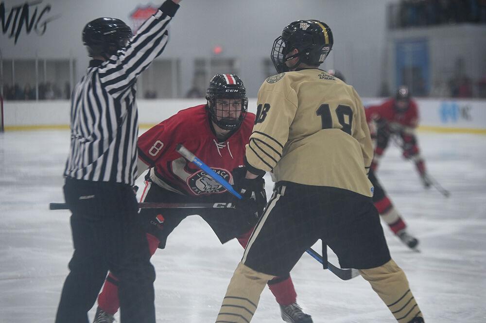 Sophomore forward Zach Herman stares down a Wake Forest player before a faceoff during the NC State Icepack&#8217;s home hockey game against the Wake Forest Demon Deacons in Invisalign Arena on Friday, Jan. 19, 2024.The Icepack beat the Deacons 7-2.
