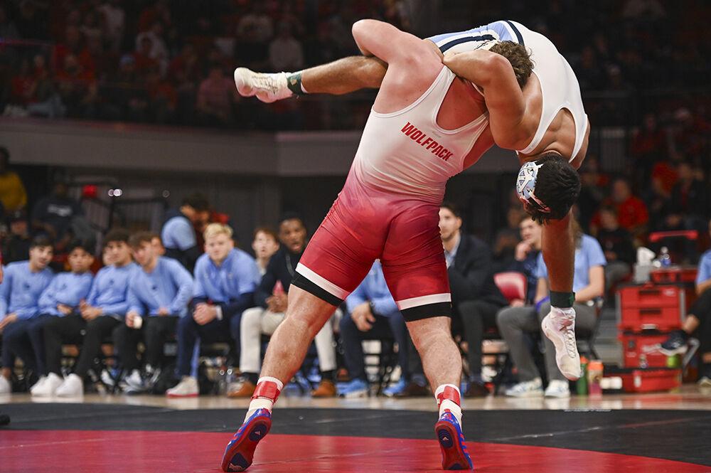 Redshirt junior Owen Trephan flips his opponent over during the wrestling match against UNC-Chapel Hill in Reynolds Coliseum on Friday, Feb. 2, 2024. Trephan won the 285 bout 20-5 by technical fall. NC State beat UNC 33-6.
