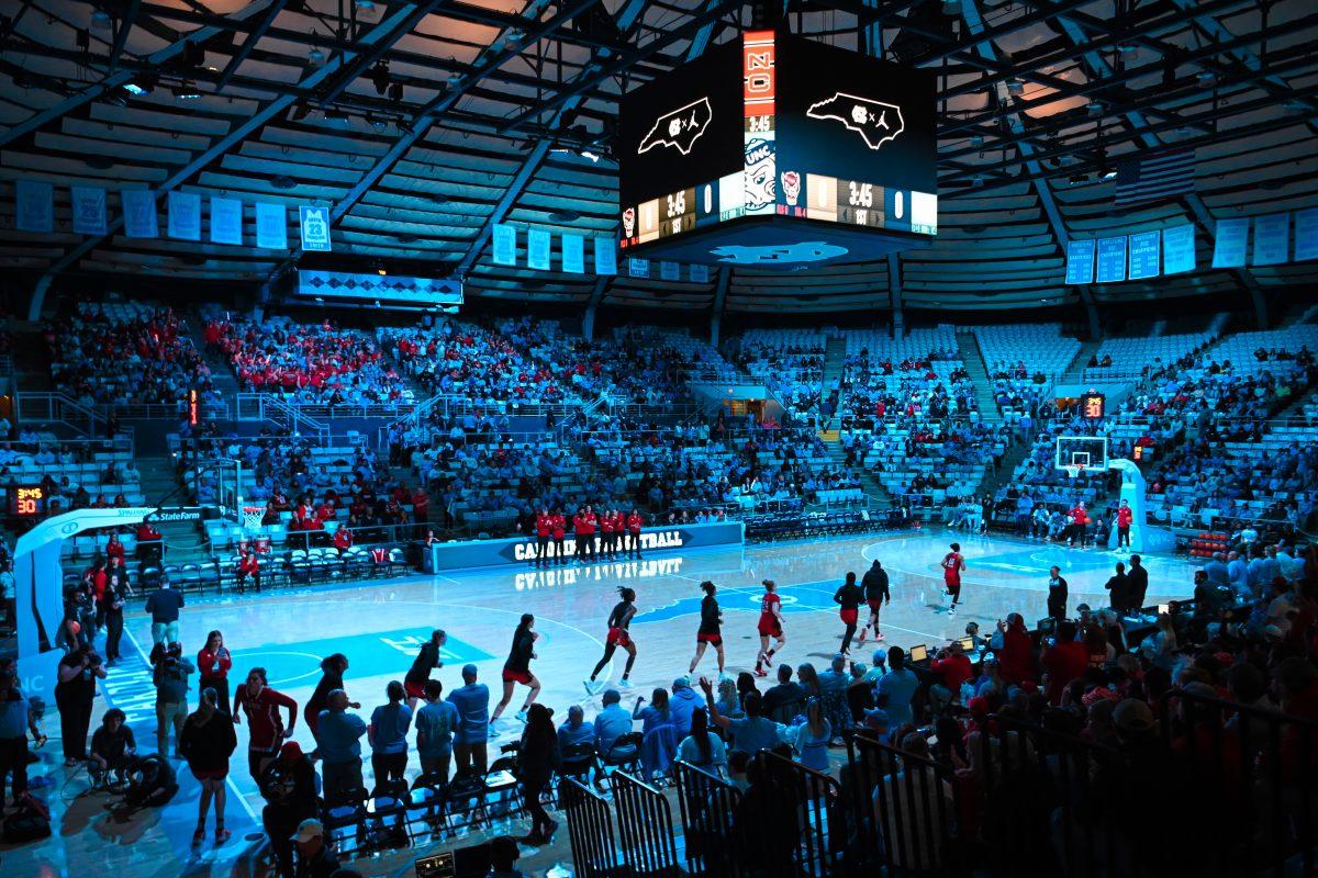 NC State runs out onto the court before the game against UNC-Chapel&#160;Hill&#160;in Carmichael Arena on Thursday, Feb. 22, 2024. NC State lost to Chapel Hill 80-70.