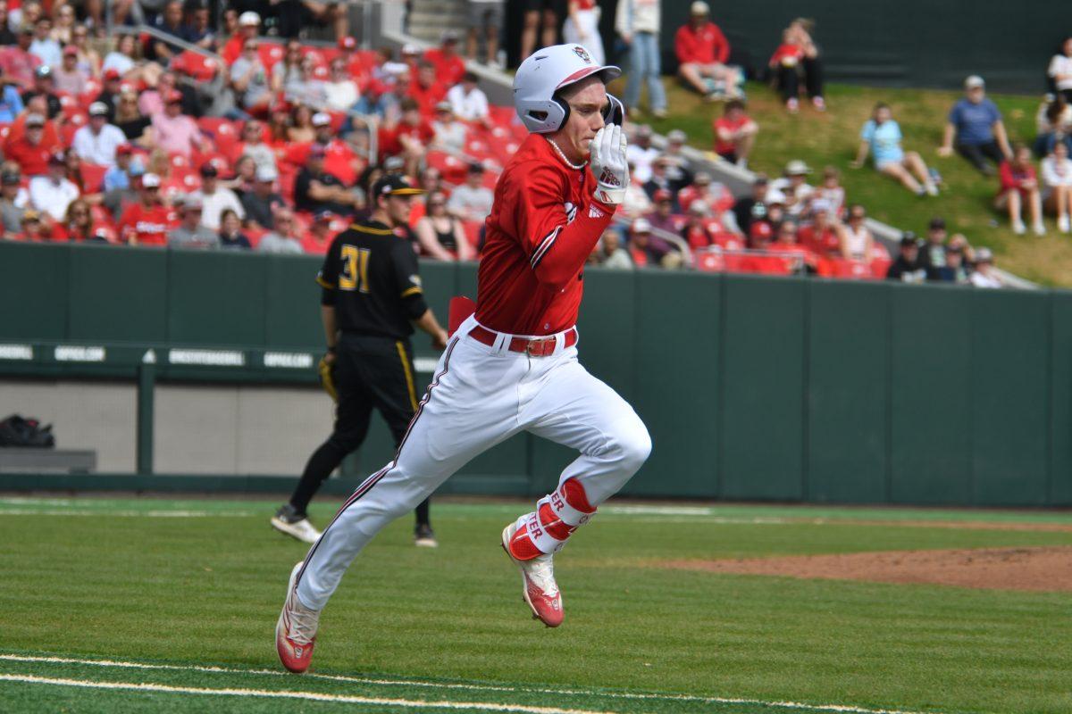 Junior shortstop Brandon Butterworth sprints to first to beat the throw during the Wolfpack's final home game in the series against the Towson Tigers on Doak Field at Dail Park on Sunday, March 3, 2024. The Wolfpack swept the Tigers, winning the final game in the series 14-4.