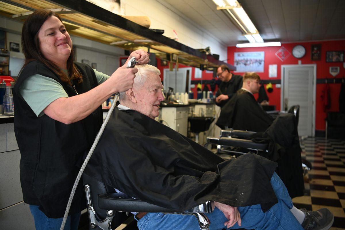 Hairdresser and wife of owner Richard Creech, Wendy, cuts the hair of former NC State professor Clay Stalnaker in Man-Mur Barbershop on Thursday, Feb. 29, 2024.