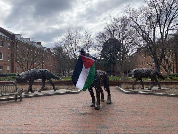 A Palestinian flag hangs from a statue in Wolf Plaza after a protest on Monday, March 4. NC State's Arab Student Organization and Students for Justice in Palestine organized the pro-Palestine protest, which began in Wolf Plaza.