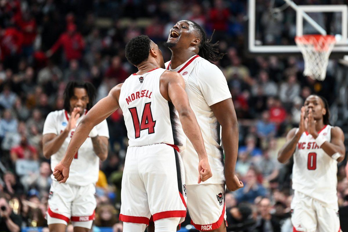 Graduate guard Casey Morsell and graduate forward DJ Burns chest bump as the clock runs out during the second round game of the NCAA Tournament against Oakland at PPG Paints Arena in Pittsburgh on Saturday, March 23, 2024. Morsell and Burns combined for 35 points. NC State beat Oakland 79-73 in overtime to advance to the Sweet 16.