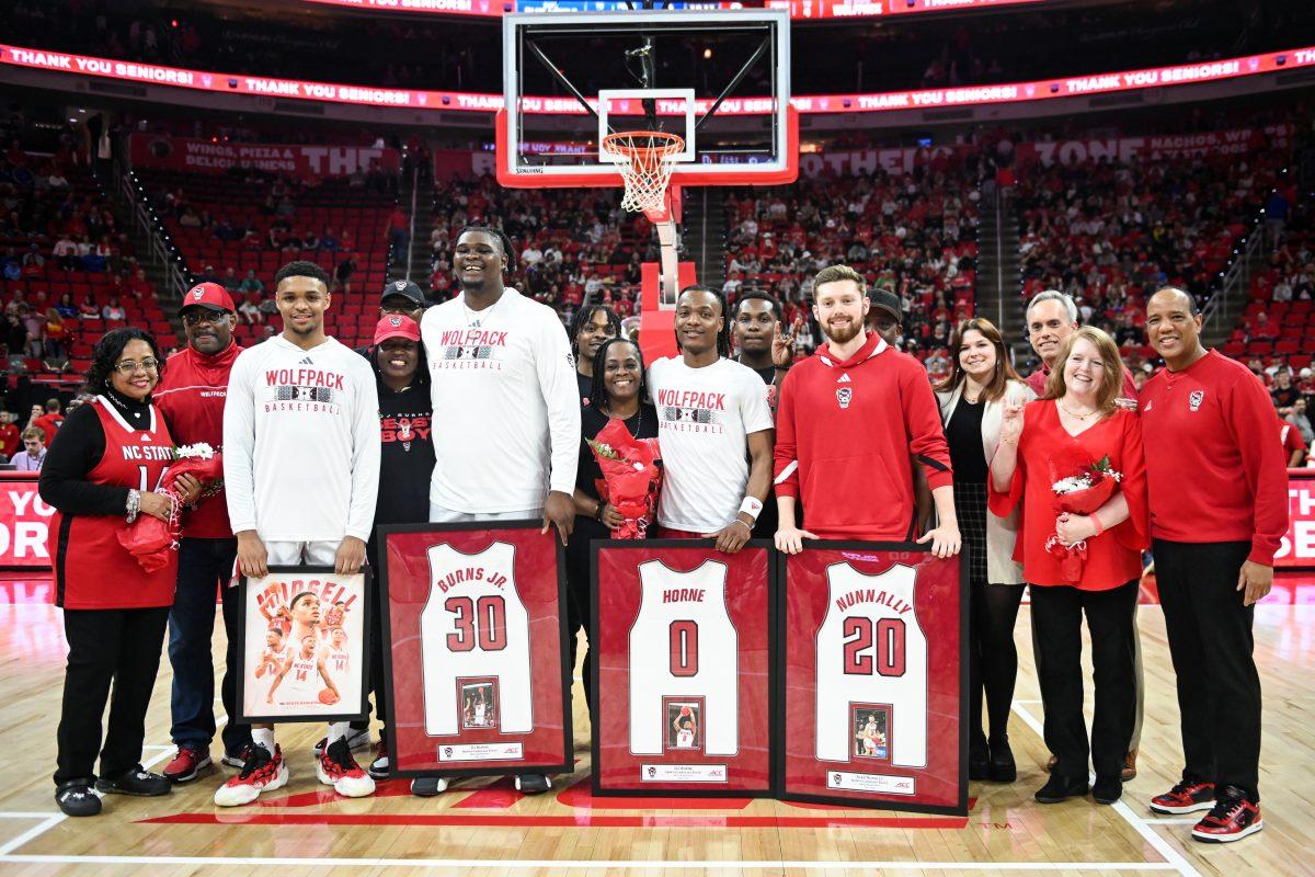 Graduate guard Casey Morsell, graduate forward DJ Burns, graduate guard DJ Horne and senior guard Alex Nunnally celebrate senior night before the game against Duke in PNC Arena on Monday, March 4, 2024. NC State lost to Duke 79-64.
