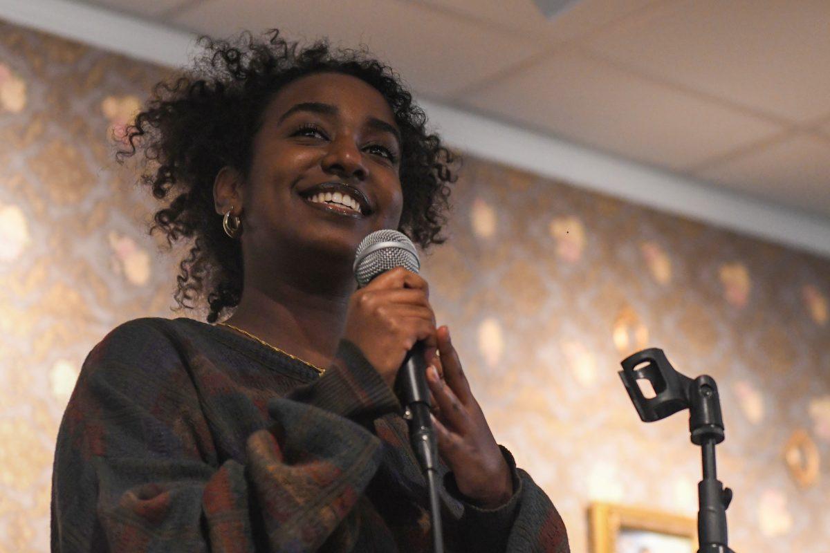 Lidia Solomon, a fourth-year studying communication, smiles at the audience during the event inside the African American Cultural Center Art Gallery and Library on Thursday, Feb. 9, 2024. Alongside Solomon's musical performance, the event featured spoken-word poetry and rap.