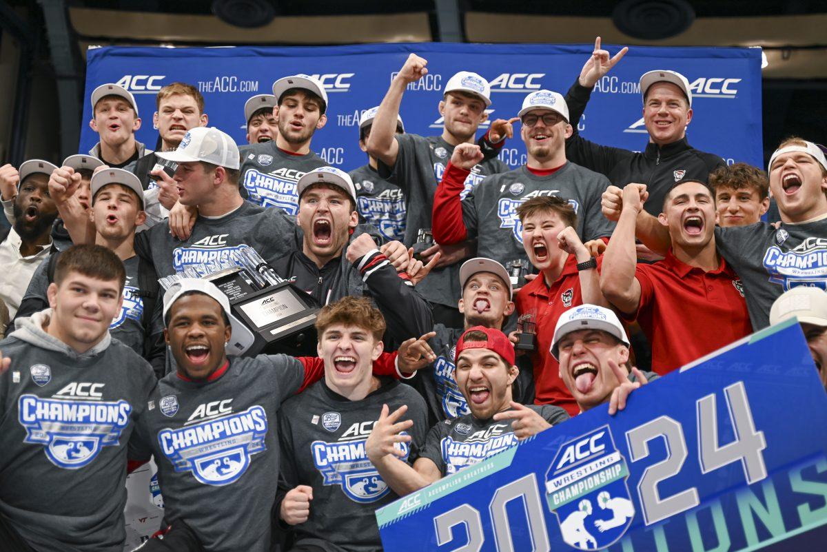 The NC State wrestling team celebrates winning the ACC Championship during the 2024 ACC Wrestling Championship in Carmichael Arena on Sunday, March 10, 2024. NC State won their sixth consecutive ACC Championship.