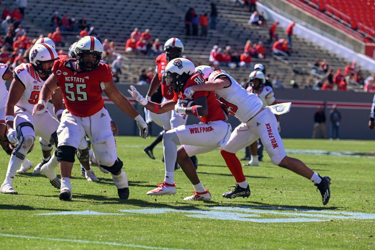Freshman wide receiver Terrell Anderson fights through the tackle during the spring game at Carter-Finley Stadium on Saturday, April 6, 2024. The Red team beat the White team 51-7.