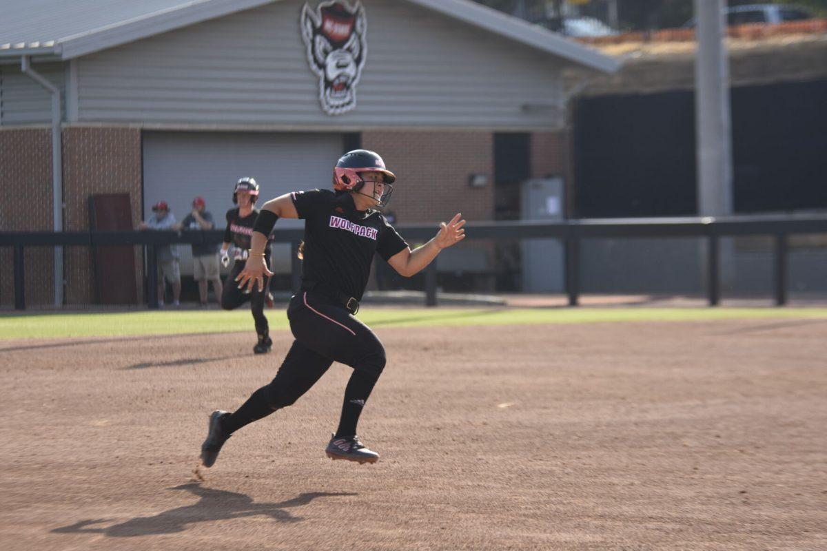 Freshman catcher Katie Raper runs to third base at the Dali Softball Stadium against Presbyterian on Saturday, April 20, 2024. Raper scored a run and a hit in three times at bat. NC State won against Presbyterian 9-0 in five innings.