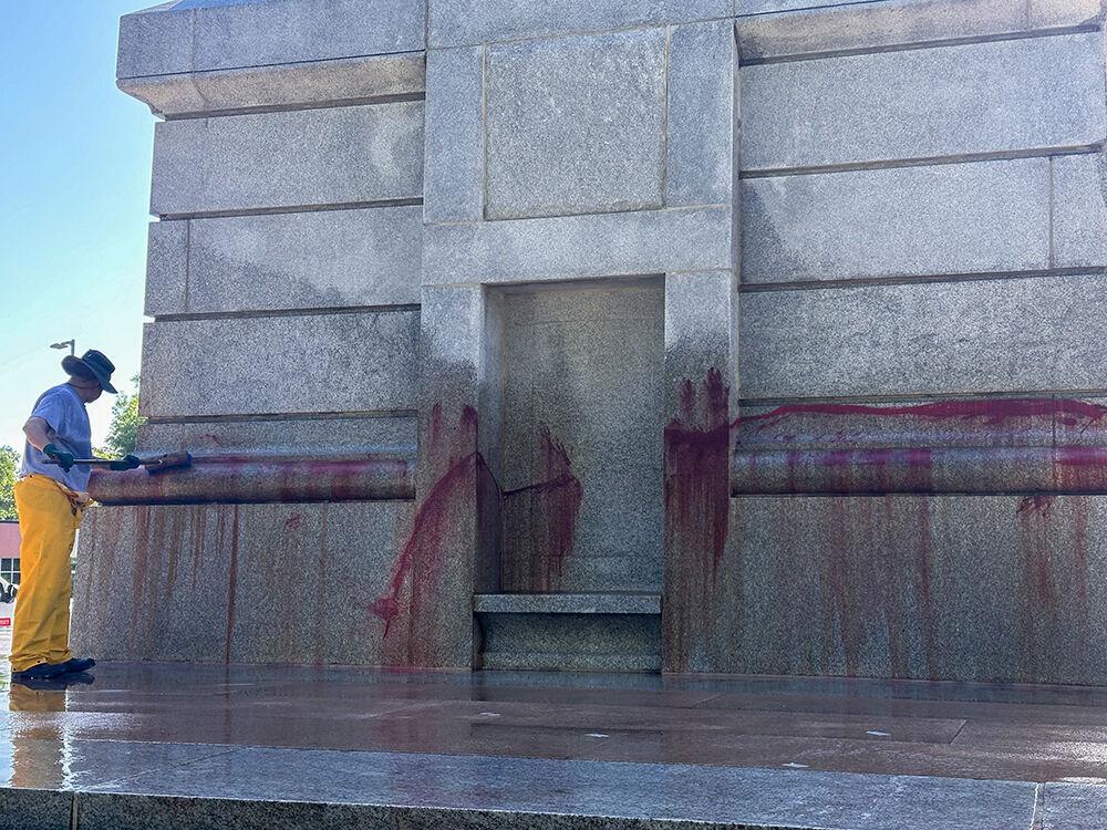 Work crews clean up graffiti spray-painted on the Memorial Belltower on Tuesday, May 28, 2024. Pro-Palestinian messages were spray-painted on the base and plaza, along with red paint to symbolize blood. NC State Police are investigating.