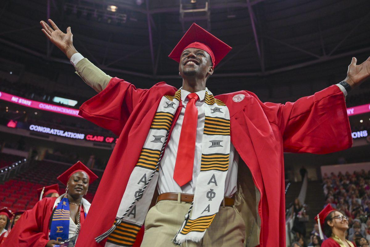 Ethan Robinson, a fourth-year studying sports management, holds his arms out during the Spring Commencement Ceremony in PNC Arena on Saturday, May 4, 2024. 6,994 degrees were given out with the youngest graduate being 18-years-old.