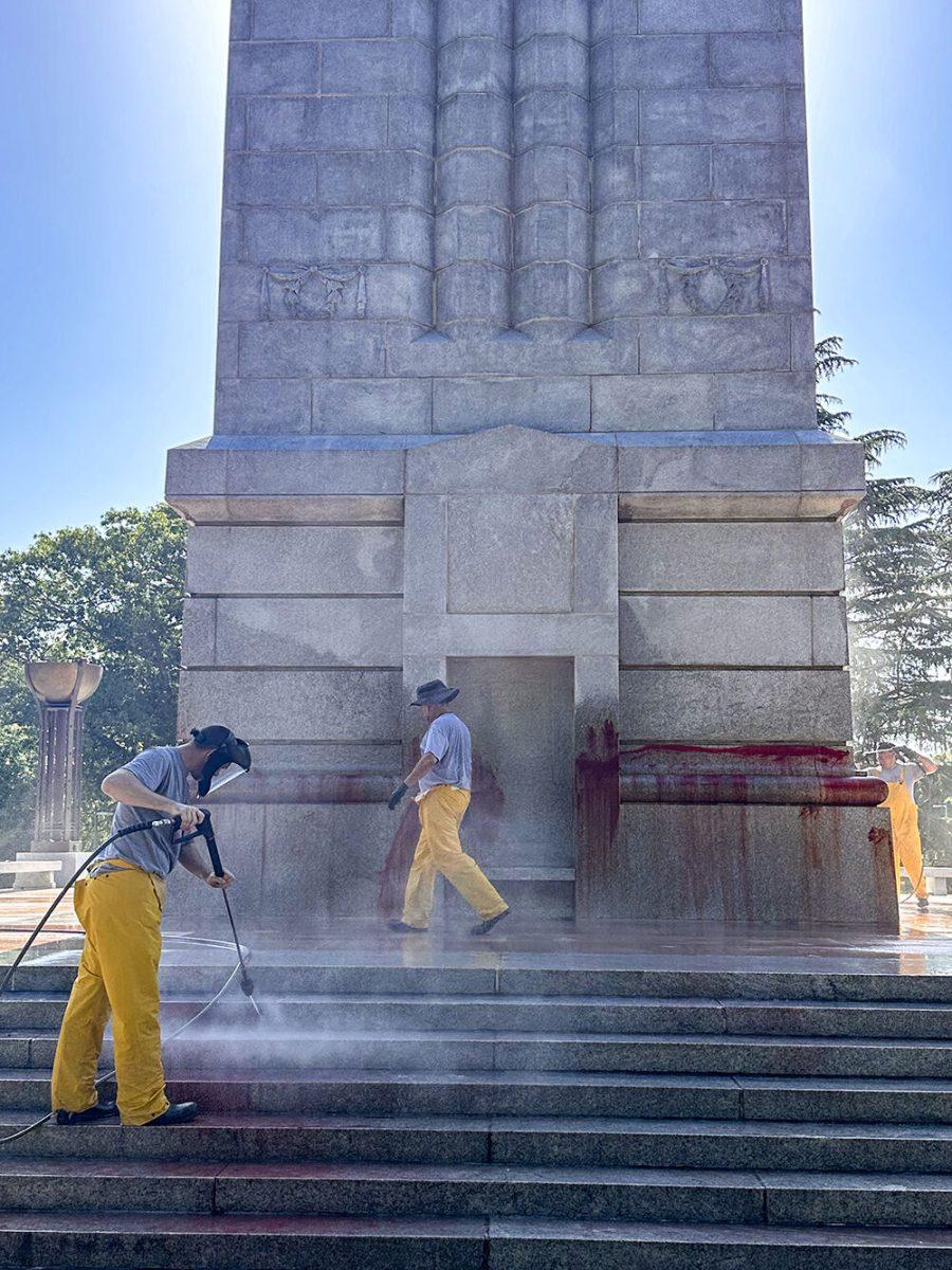 Work crews clean up graffiti spray-painted on the Memorial Belltower on Tuesday, May 28, 2024. Pro-Palestinian messages were spray-painted on the base and plaza, along with red paint to symbolize blood. NC State Police are investigating.