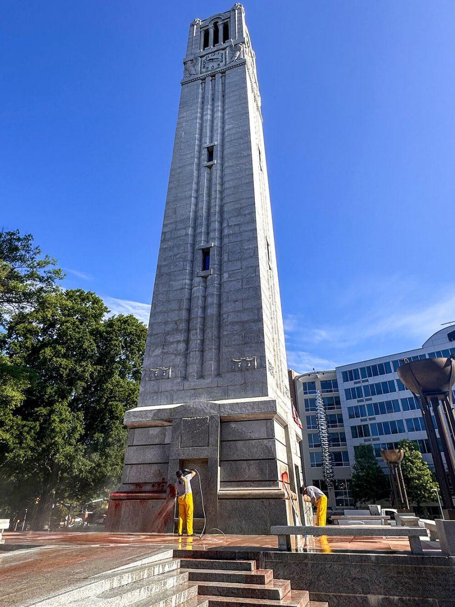 Work crews clean up graffiti spray-painted on the Memorial Belltower on Tuesday, May 28, 2024. Pro-Palestinian messages were spray-painted on the base and plaza, along with red paint to symbolize blood. NC State Police are investigating.