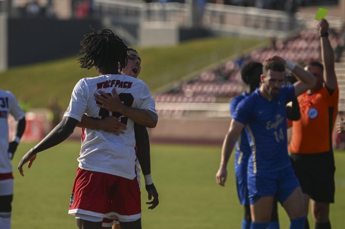 Senior midfielder Henrique Santos embraces sophomore forward Donavan Phillip after Phillip won the Wolfpack a penalty kick in the 88th minute of the home game against the Florida Gulf Coast Eagles at Dail Soccer Field on Sunday, Aug. 25, 2024. The Wolfpack beat the Eagles 1-0.