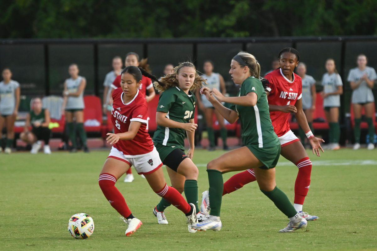 Freshman midfielder Mana Nakata dribbles away from defenders during NC State's home game against Charlotte at Dail Soccer Field on Thursday, Aug. 28, 2024. The Wolfpack beat the 49ers 3-1.