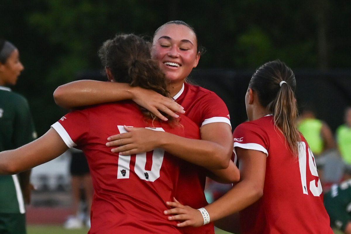 Senior midfielder Annika Wohner, graduate midfielder Jaiden Thomas and freshman forward Antonella Mazziotto embrace each other after Thomas' goal during NC State's home game against Charlotte at Dail Soccer Field on Thursday, Aug. 28, 2024. The Wolfpack beat the 49ers 3-1.