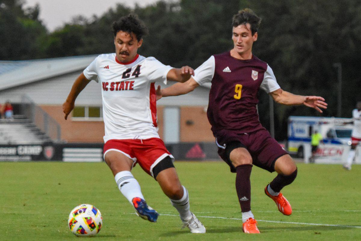 Fifth-year midfielder Adam Fam fights for possession of the ball during the soccer game against Winthrop at Dail Soccer Field on Tuesday, Sept. 10, 2024. The Wolfpack beat the Eagles 7-0.