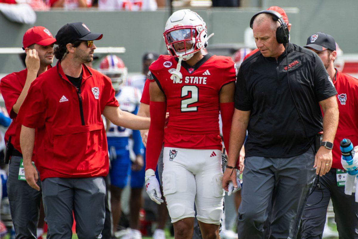 Sophomore cornerback Brandon Cisse walks off the field with head coach Dave Doeren after an injury during the game against LA Tech at Carter-Finley Stadium on Saturday, Sept. 14, 2024. The Wolfpack beat the Bulldogs 30-20.