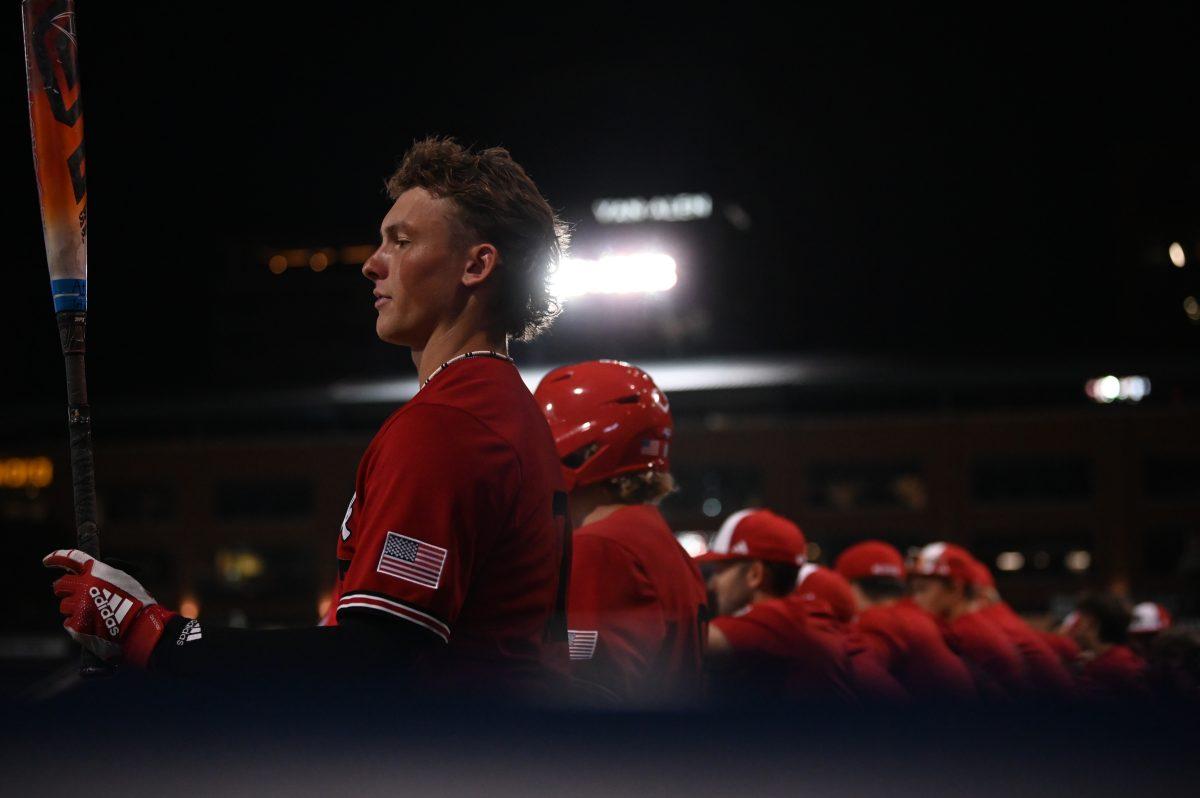 Sophomore infielder Matt Ossenfort warms up at the edge of the dugout during one of the Wolfpack's games against the Duke Blue Devils at Durham Bulls Athletic Park on Friday. Oct. 4, 2024. The Blue Devils beat the Wolfpack 5-2 in both contests.
